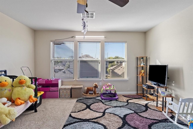 playroom featuring visible vents, ceiling fan, and carpet