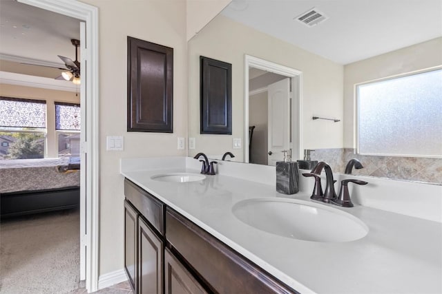 bathroom with visible vents, ceiling fan, ensuite bath, and a sink