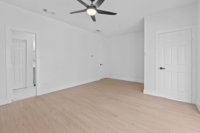 unfurnished bedroom with baseboards, visible vents, ceiling fan, and light wood finished floors