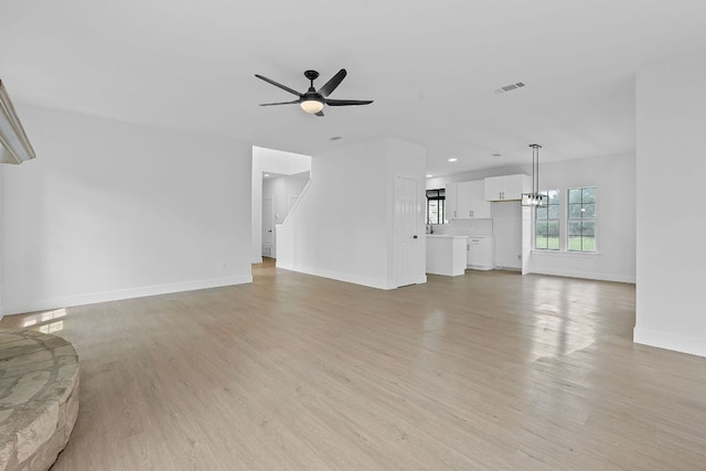 300 Fawn Ln, Georgetown, TX 78628 - unfurnished living room featuring light wood finished floors, ceiling fan, and recessed lighting