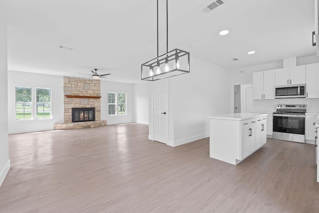 300 Fawn Ln, Georgetown, TX 78628 - kitchen featuring appliances with stainless steel finishes, ceiling fan, light wood-type flooring, healthy amount of natural light, and recessed lighting