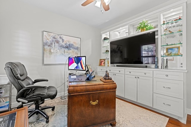 office space featuring baseboards and ceiling fan
