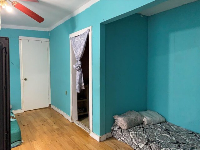 4811 Santa Anna St, Austin, TX 78721 - bedroom with light wood-type flooring, ornamental molding, and a ceiling fan