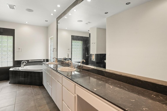 507 Arbors Cir, Elgin, TX 78621 - full bathroom featuring a garden tub, double vanity, tile patterned floors, and recessed lighting