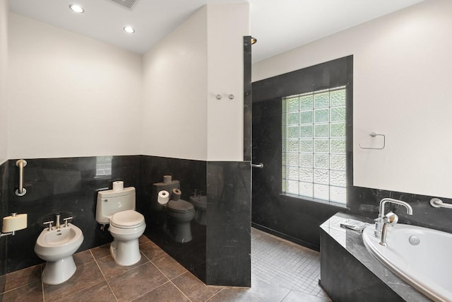 507 Arbors Cir, Elgin, TX 78621 - full bath featuring a bidet, a garden tub, a walk in shower, a wainscoted wall, and recessed lighting