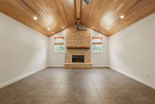 507 Arbors Cir, Elgin, TX 78621 - unfurnished living room featuring wood ceiling, plenty of natural light, a stone fireplace, dark tile patterned flooring, and ceiling fan