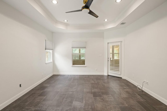 507 Arbors Cir, Elgin, TX 78621 - empty room featuring a raised ceiling, ceiling fan, recessed lighting, ornamental molding, and dark wood finished floors