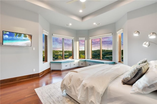 bedroom featuring baseboards, recessed lighting, wood finished floors, and visible vents