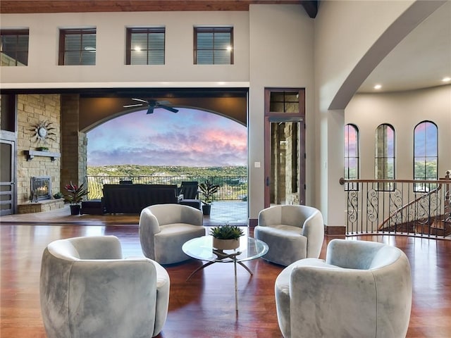 interior space with recessed lighting, ceiling fan, a stone fireplace, and wood finished floors