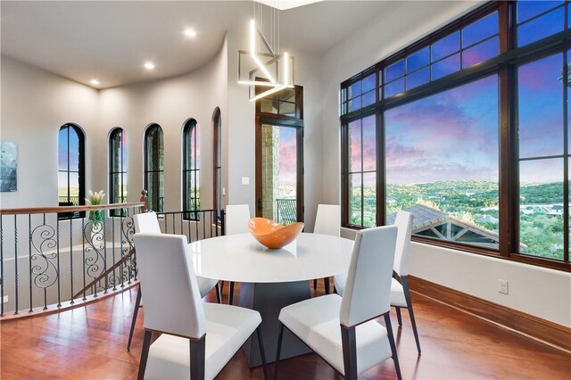 dining space with recessed lighting, wood finished floors, and a healthy amount of sunlight