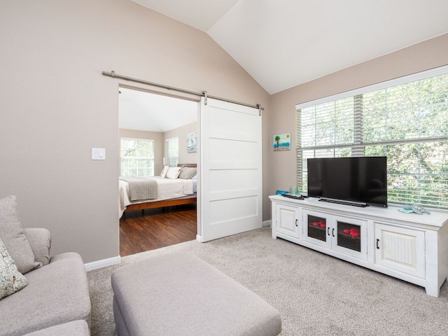4525 Three Arrows Ct, Cedar Park, TX 78613 - living room featuring a barn door, lofted ceiling, carpet flooring, and baseboards