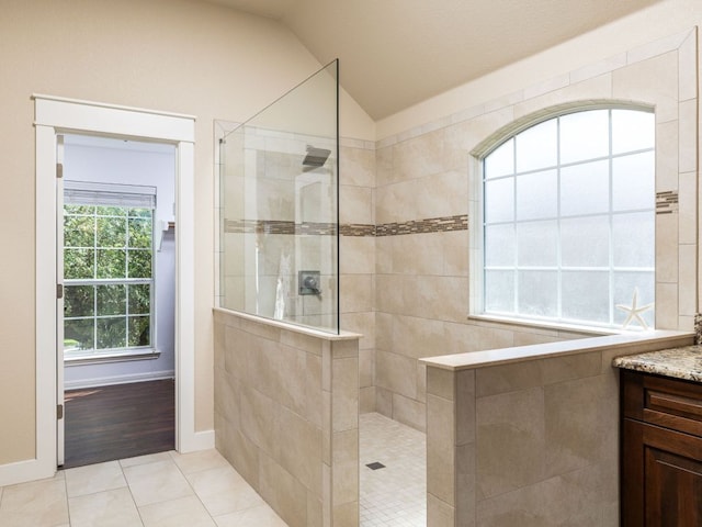4525 Three Arrows Ct, Cedar Park, TX 78613 - bathroom featuring lofted ceiling, a walk in shower, vanity, tile patterned floors, and baseboards