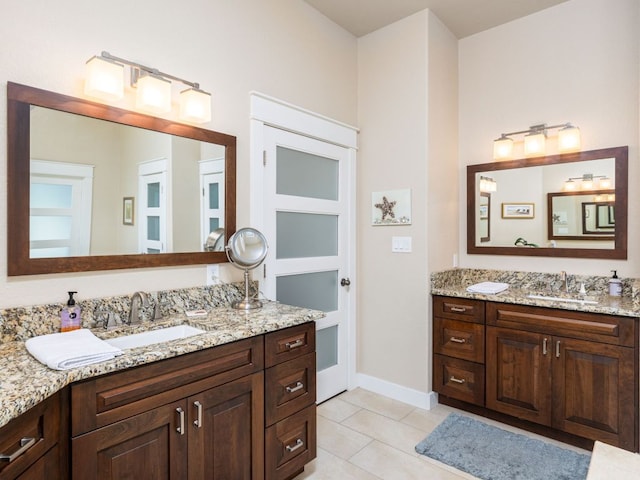 4525 Three Arrows Ct, Cedar Park, TX 78613 - full bathroom with two vanities, tile patterned flooring, and baseboards