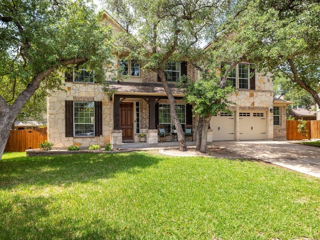 4525 Three Arrows Ct, Cedar Park, TX 78613 - view of front of home featuring stone siding, a porch, concrete driveway, and an attached garage