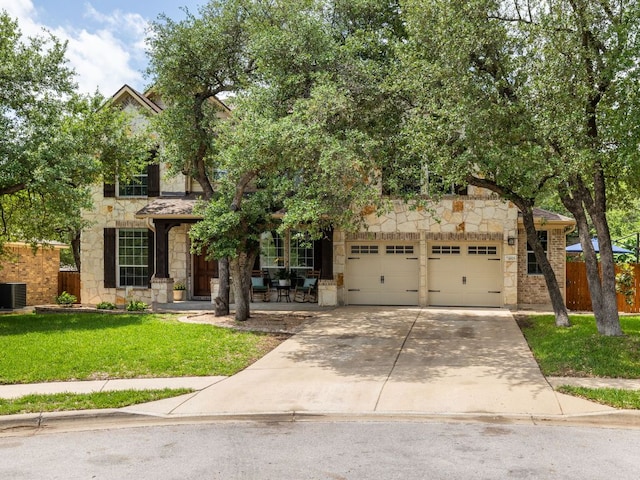 4525 Three Arrows Ct, Cedar Park, TX 78613 - obstructed view of property featuring stone siding, a garage, concrete driveway, and central AC unit