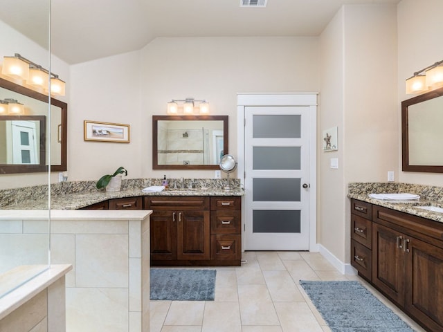 4525 Three Arrows Ct, Cedar Park, TX 78613 - full bathroom with two vanities, tile patterned floors, vaulted ceiling, and tiled shower