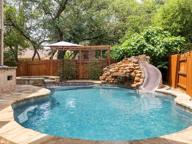 4525 Three Arrows Ct, Cedar Park, TX 78613 - view of pool with a gazebo, a fenced backyard, a water slide, and a pool with connected hot tub