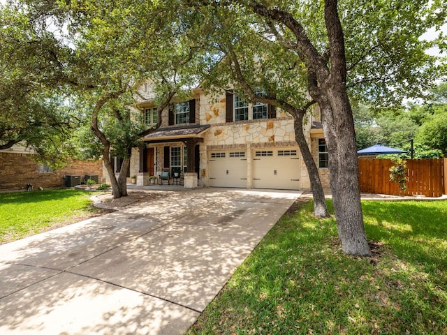 4525 Three Arrows Ct, Cedar Park, TX 78613 - view of front of house with stone siding, an attached garage, driveway, central air condition unit, and covered porch