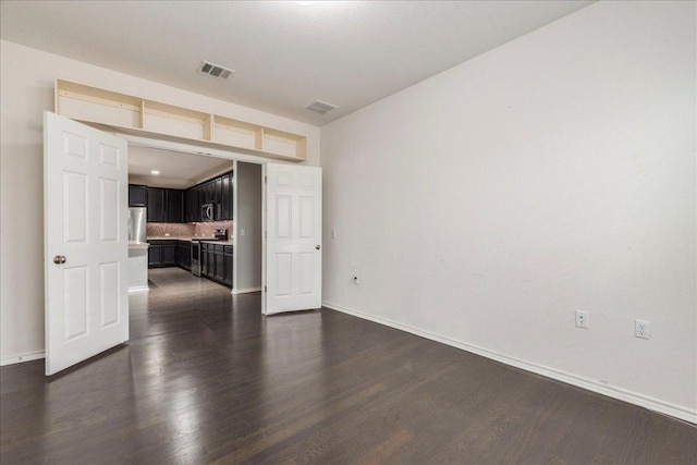 13305 Henneman Dr, Pflugerville, TX 78660 - unfurnished living room with dark wood-style flooring, visible vents, and baseboards