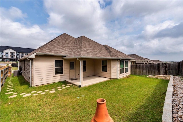 13305 Henneman Dr, Pflugerville, TX 78660 - back of property featuring a fenced backyard, central AC unit, a yard, and a patio area