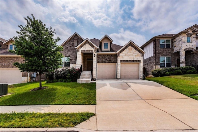 13305 Henneman Dr, Pflugerville, TX 78660 - view of front of house with a front yard, driveway, and stone siding