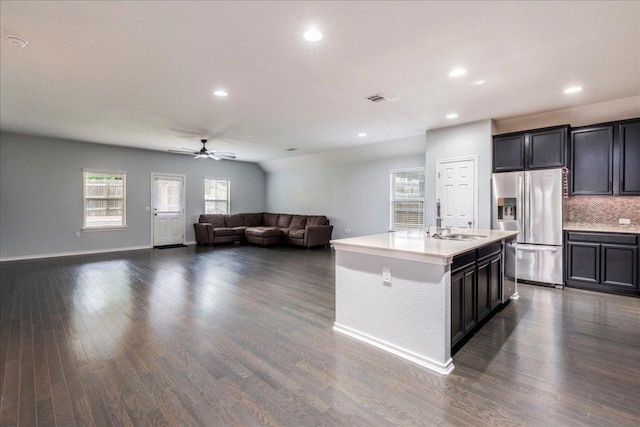 13305 Henneman Dr, Pflugerville, TX 78660 - kitchen with stainless steel fridge, backsplash, a sink, visible vents, and a ceiling fan