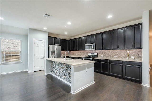 13305 Henneman Dr, Pflugerville, TX 78660 - kitchen with tasteful backsplash, a sink, appliances with stainless steel finishes, visible vents, and dark wood-style floors
