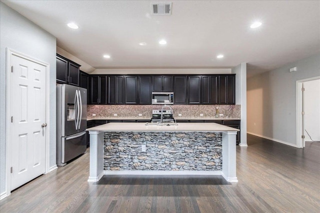 13305 Henneman Dr, Pflugerville, TX 78660 - kitchen with visible vents, wood finished floors, appliances with stainless steel finishes, and light countertops