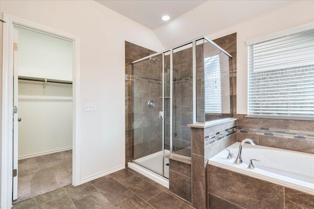 13305 Henneman Dr, Pflugerville, TX 78660 - full bathroom with a bath, a walk in closet, a shower stall, and baseboards