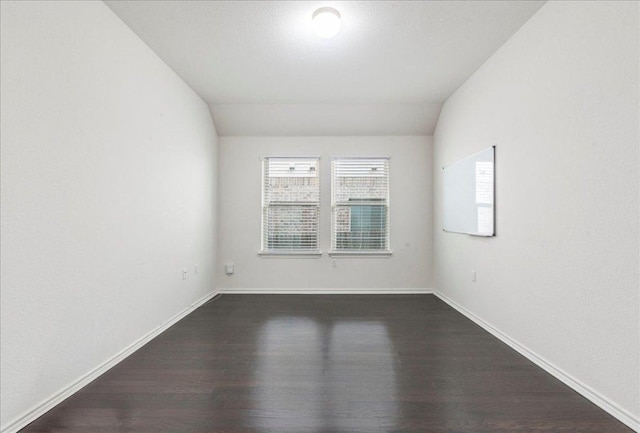 13305 Henneman Dr, Pflugerville, TX 78660 - spare room featuring dark wood-style floors, baseboards, and vaulted ceiling