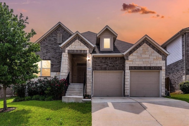 13305 Henneman Dr, Pflugerville, TX 78660 - french country style house featuring a yard, brick siding, driveway, stone siding, and an attached garage