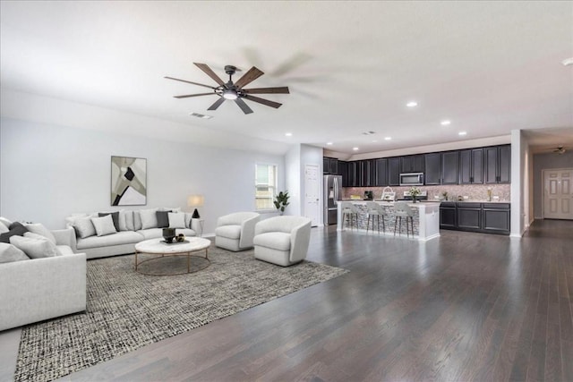 13305 Henneman Dr, Pflugerville, TX 78660 - living room featuring dark wood-style flooring, visible vents, a ceiling fan, and recessed lighting