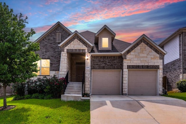 13305 Henneman Dr, Pflugerville, TX 78660 - view of front of home with driveway, stone siding, a lawn, brick siding, and a garage