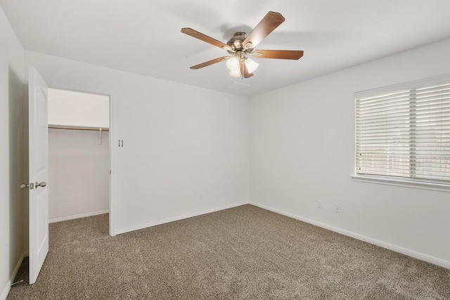 155 San Miniato St, Georgetown, TX 78628 - unfurnished bedroom featuring carpet floors, a walk in closet, baseboards, ceiling fan, and a closet
