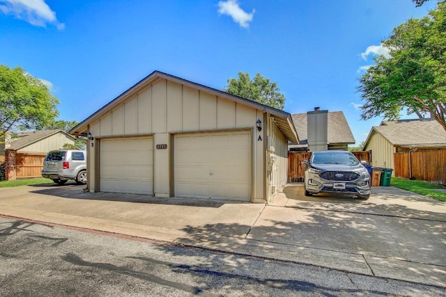 1515 W Braker Ln Unit A, Austin, TX 78758 - view of front facade featuring a detached garage, an outdoor structure, and board and batten siding