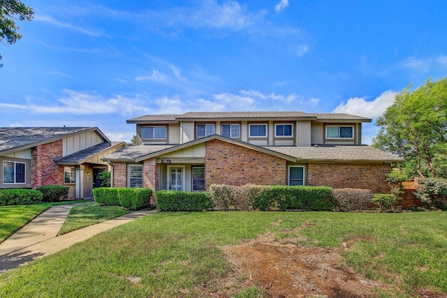 1515 W Braker Ln Unit A, Austin, TX 78758 - view of front of property with a front lawn, stucco siding, brick siding, and a shingled roof