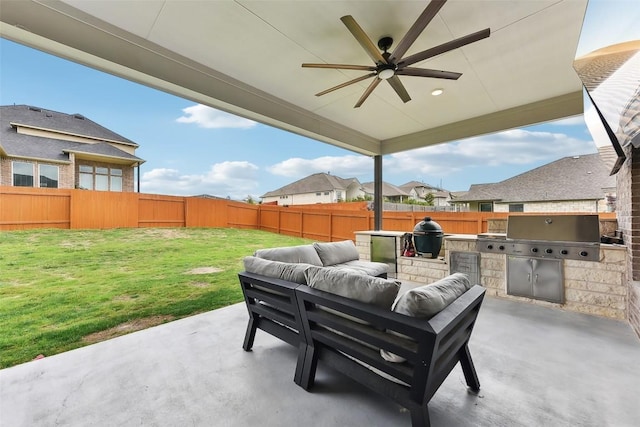 361 Wild Pecan Loop, Buda, TX 78610 - fenced backyard with exterior kitchen, a patio, an outdoor living space, and a ceiling fan