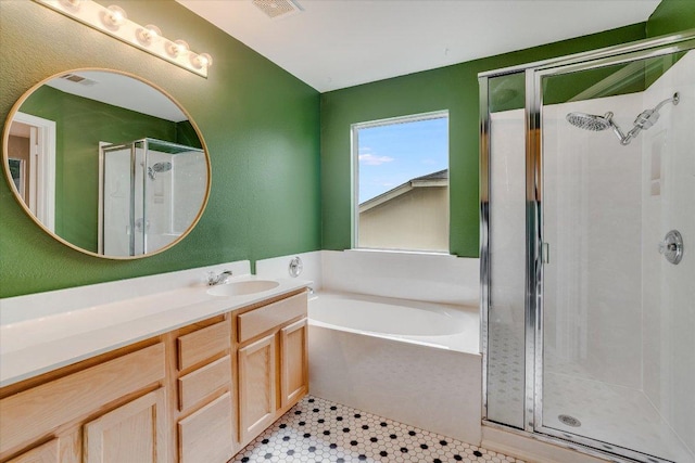 bathroom featuring a stall shower, visible vents, a bath, and vanity