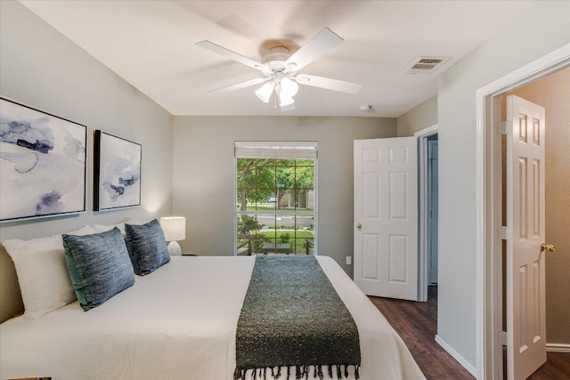bedroom featuring visible vents, ceiling fan, and dark wood-type flooring