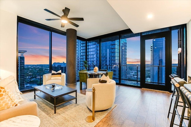84 E Ave Unit 3909, Austin, TX 78701 - living area with a view of city, wood finished floors, ceiling fan, and floor to ceiling windows