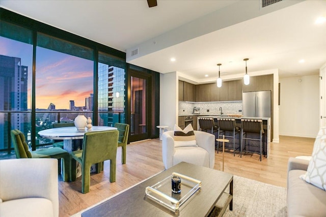 84 E Ave Unit 3909, Austin, TX 78701 - living area with recessed lighting, light wood finished floors, a view of city, visible vents, and floor to ceiling windows
