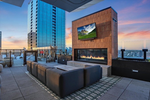 84 E Ave Unit 3909, Austin, TX 78701 - patio terrace at dusk featuring an outdoor living space with a fireplace
