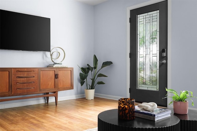 interior space featuring plenty of natural light, light wood-style flooring, and baseboards