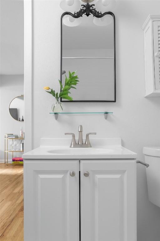 5707 Ave G, Austin, TX 78752 - bathroom featuring vanity, toilet, and wood finished floors