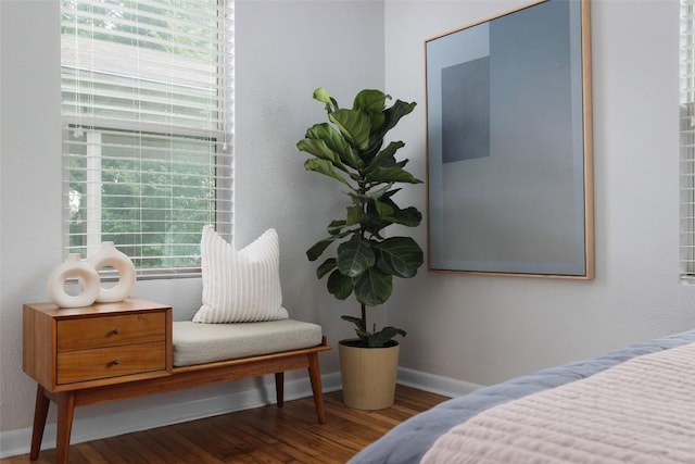 bedroom with wood finished floors and baseboards