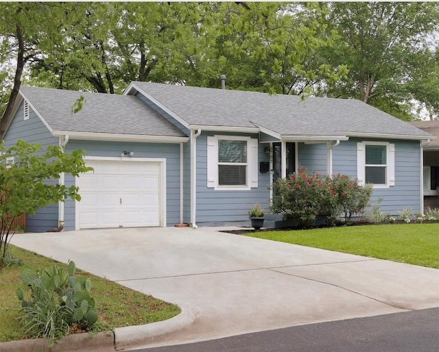 ranch-style home featuring driveway, a shingled roof, a front lawn, and a garage