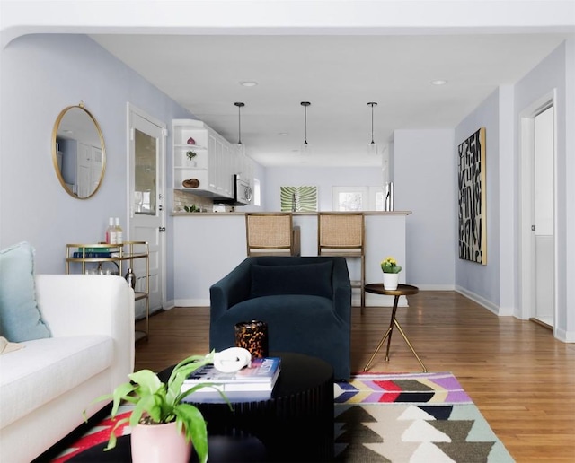 5707 Ave G, Austin, TX 78752 - living room with wood finished floors, baseboards, and recessed lighting