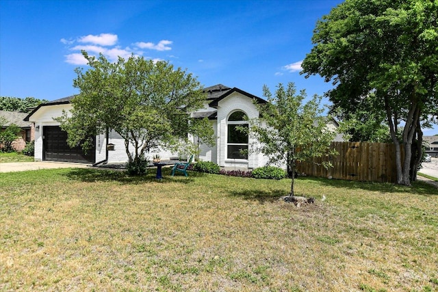 2208 Mimosa Trl, Round Rock, TX 78664 - view of front facade featuring a front lawn, driveway, an attached garage, and fence