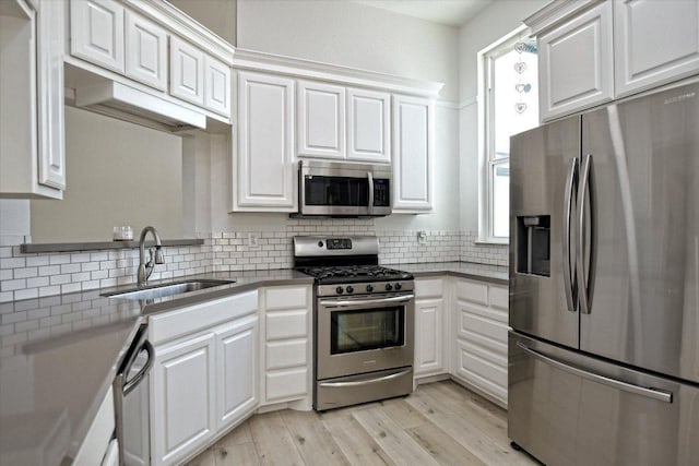 2208 Mimosa Trl, Round Rock, TX 78664 - kitchen featuring a sink, white cabinetry, and stainless steel appliances