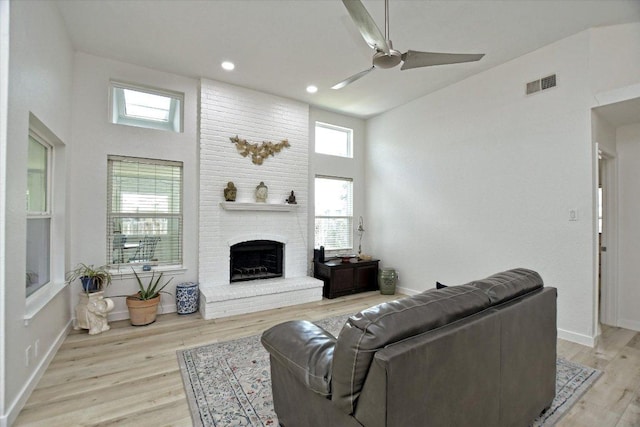2208 Mimosa Trl, Round Rock, TX 78664 - living area featuring visible vents, ceiling fan, light wood-type flooring, a fireplace, and high vaulted ceiling